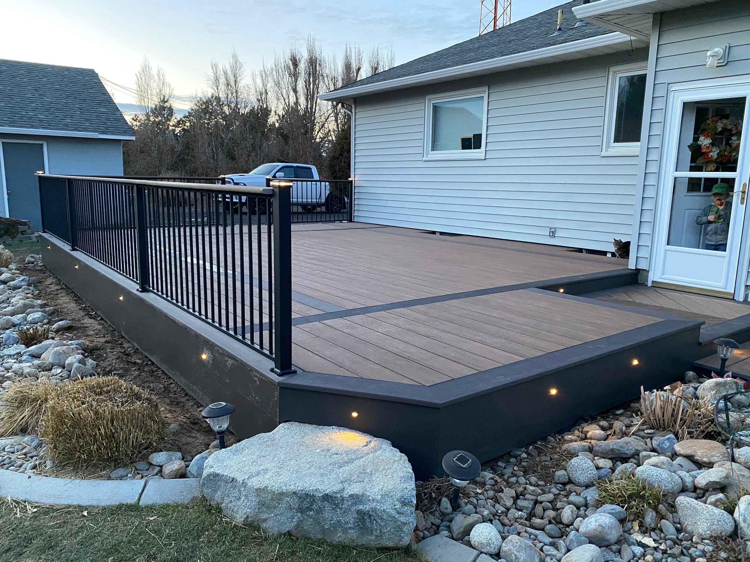 Brown composite deck with dark fascia, recessed lights