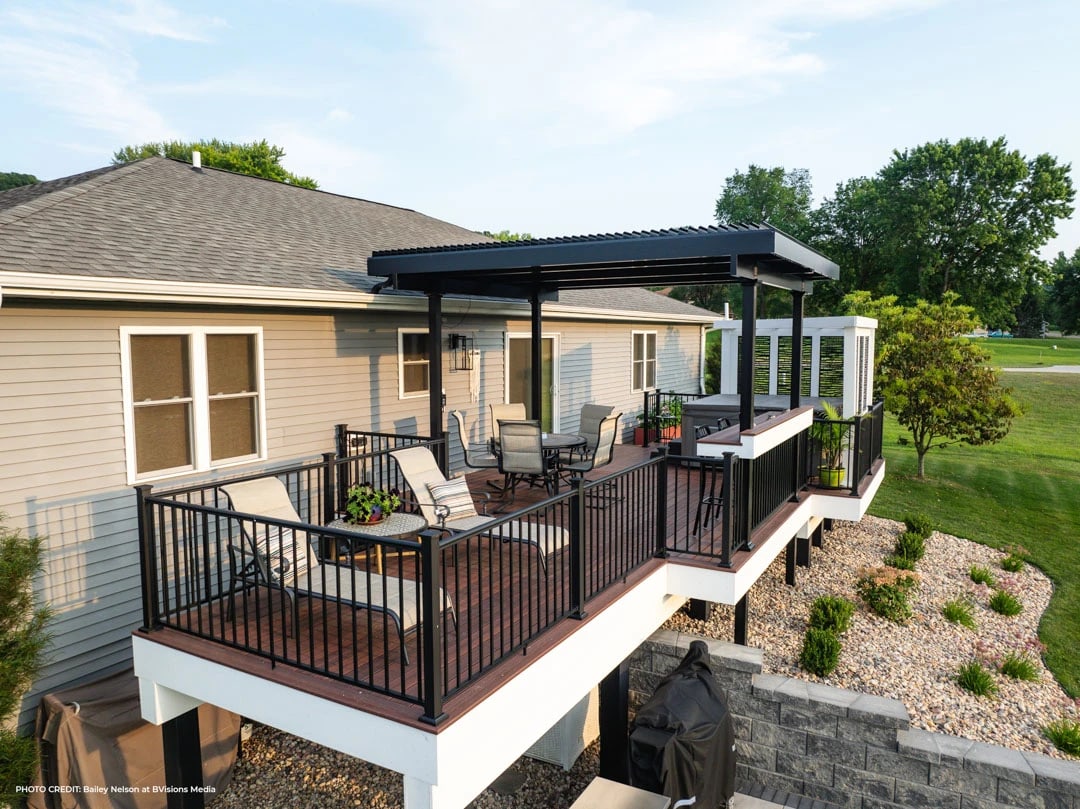 Deck with black railing and pergola.
