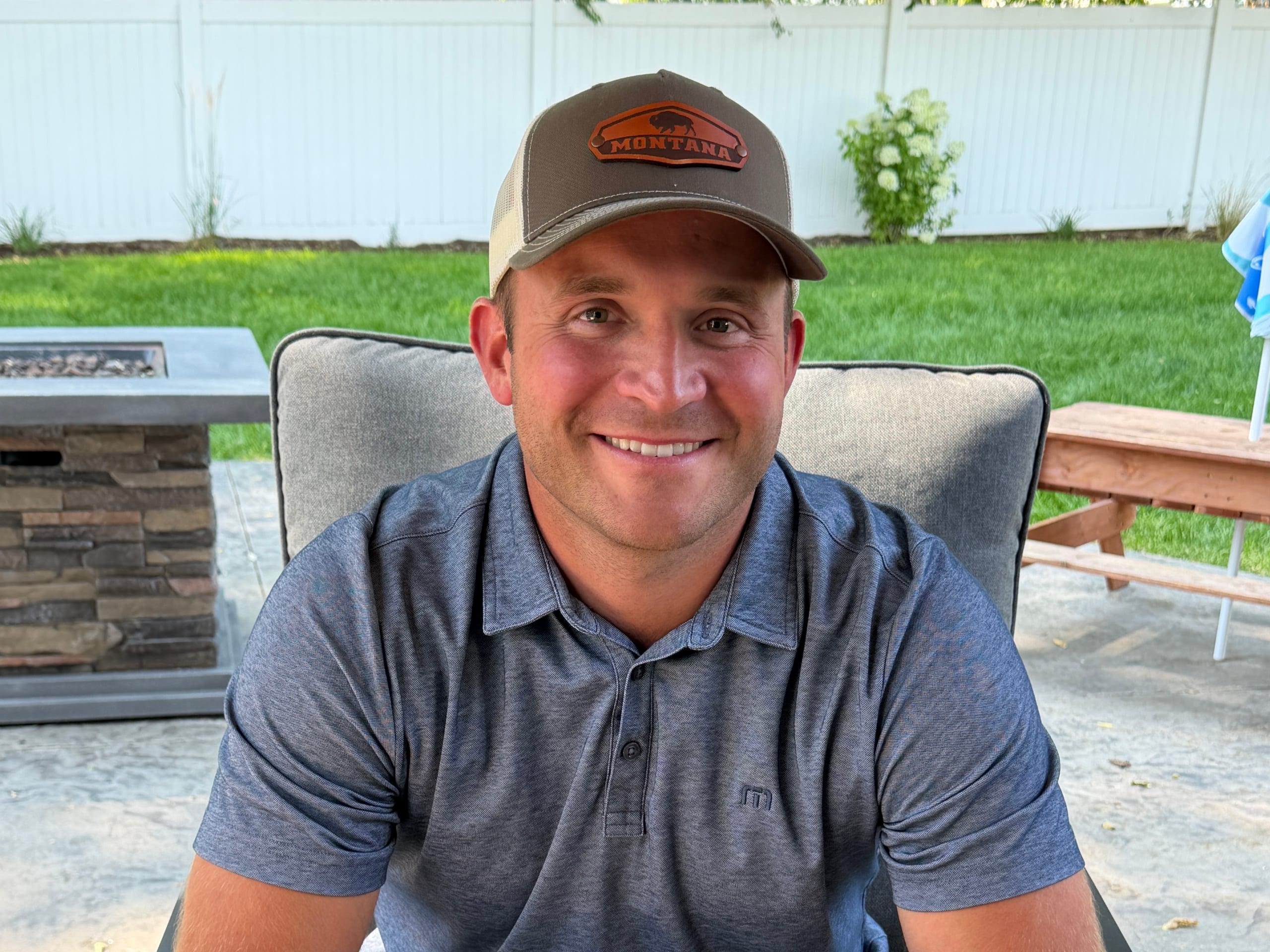 Mike Schupp, local operator of Dynamic Decks in Idaho Falls, seated on a backyard patio